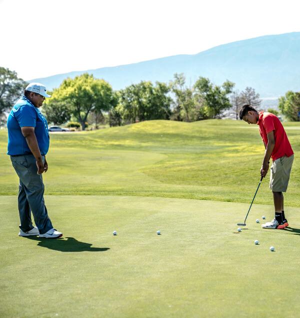 A coaching candidate talking with an Energy Fist Golf representative